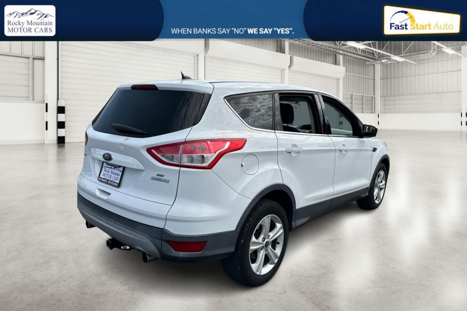 2013 White Ford Escape SE FWD (1FMCU0GX0DU) with an 1.6L L4 DOHC 16V engine, 6-Speed Automatic transmission, located at 7755 State Street, Midvale, UT, 84047, (801) 753-9063, 40.610329, -111.892159 - Photo#2