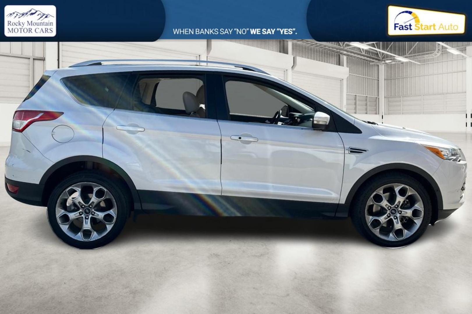 2014 White Ford Escape Titanium 4WD (1FMCU9J96EU) with an 2.0L L4 DOHC 16V engine, 6-Speed Automatic transmission, located at 767 S State Road, Pleasant Grove, UT, 84062, (801) 785-1058, 40.354839, -111.736687 - Photo#1