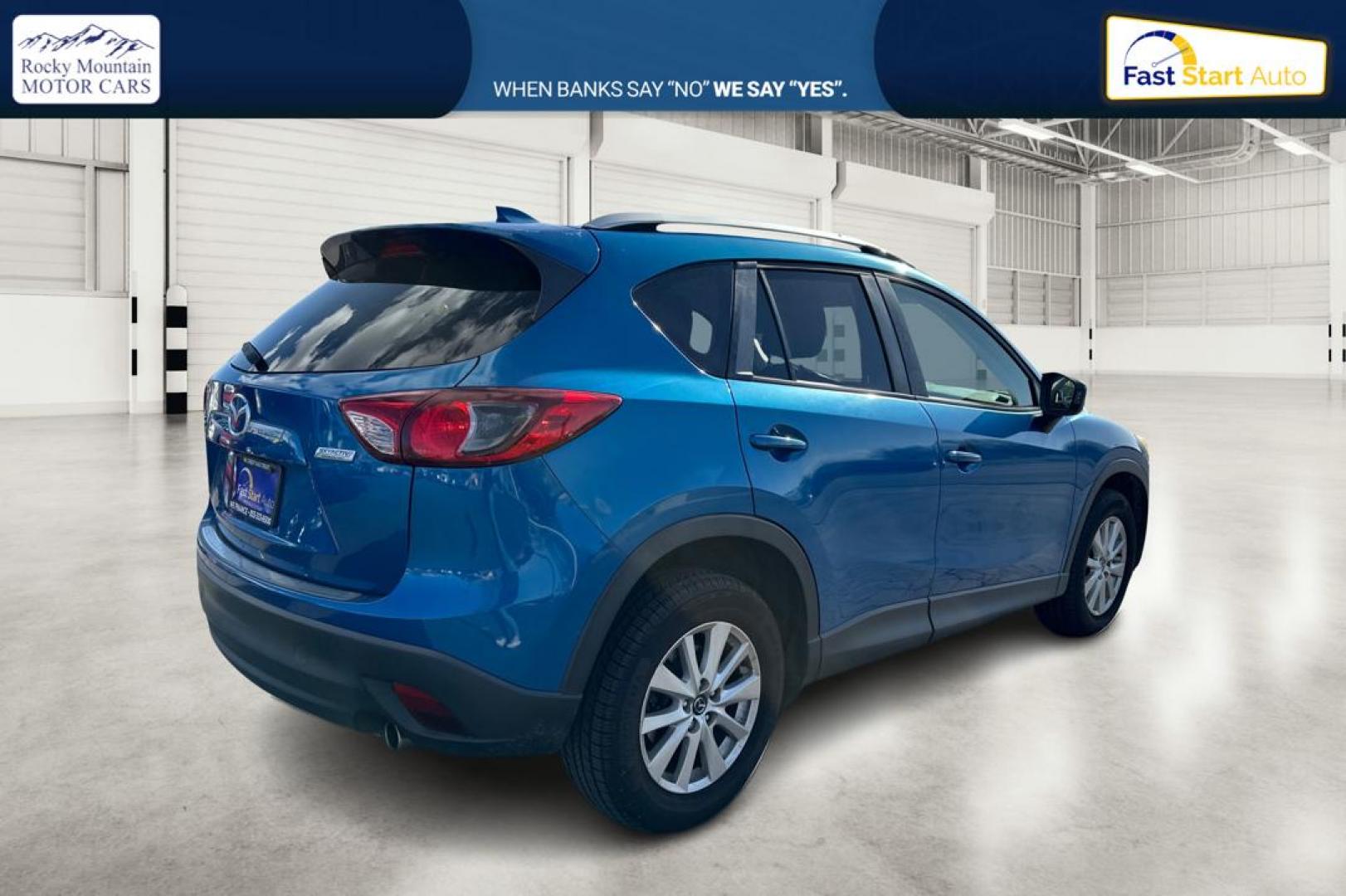 2014 Blue Mazda CX-5 Touring (JM3KE2CY1E0) with an 2.5L L4 DOHC 16V engine, 6-Speed Automatic transmission, located at 7755 State Street, Midvale, UT, 84047, (801) 753-9063, 40.610329, -111.892159 - Photo#2