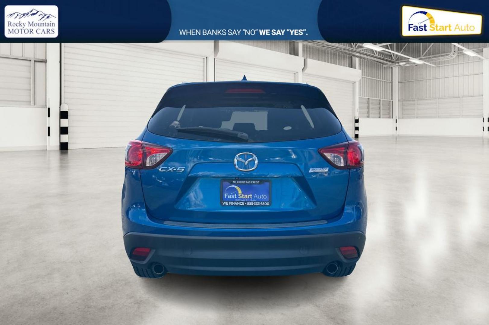 2014 Blue Mazda CX-5 Touring (JM3KE2CY1E0) with an 2.5L L4 DOHC 16V engine, 6-Speed Automatic transmission, located at 7755 State Street, Midvale, UT, 84047, (801) 753-9063, 40.610329, -111.892159 - Photo#4